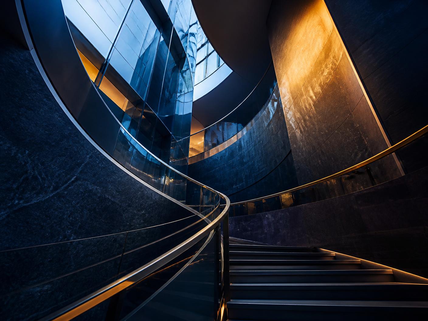 Curved staircase inside a modern navy and brass corporate atrium